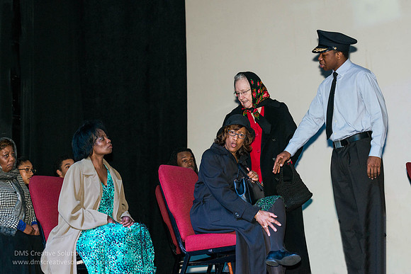 Rosa Parks being told to move from a seat in the front of the bus by a white lady and the bus driver.