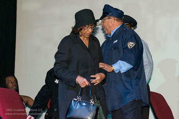 Rosa Parks being removed by the police officer.