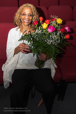 Carolyn Moore with her flowers and glass plaque.